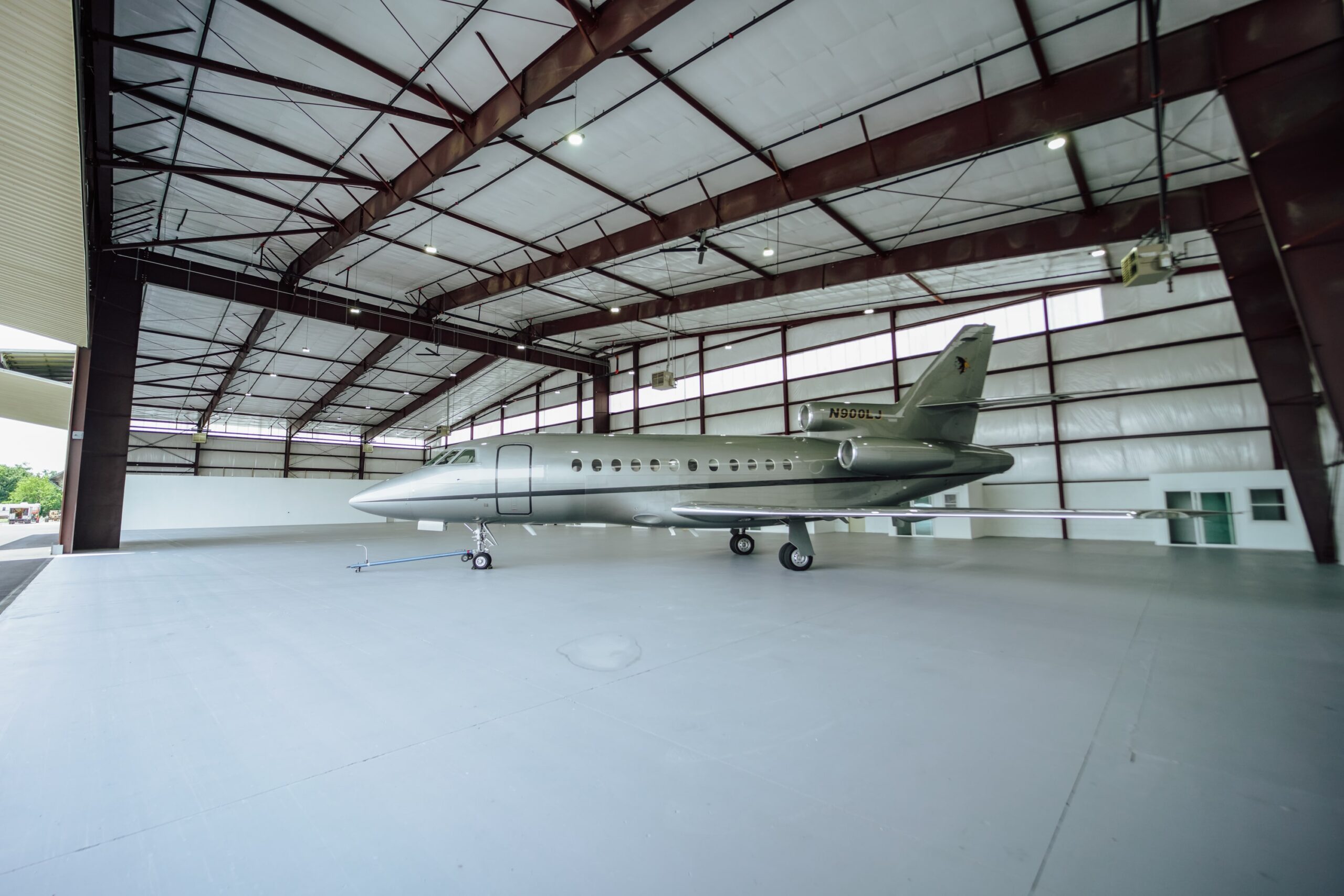Image of a spacious hangar with a jet stored inside.